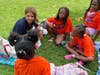 Schools superintendent Madeline Negron reads and kids. 