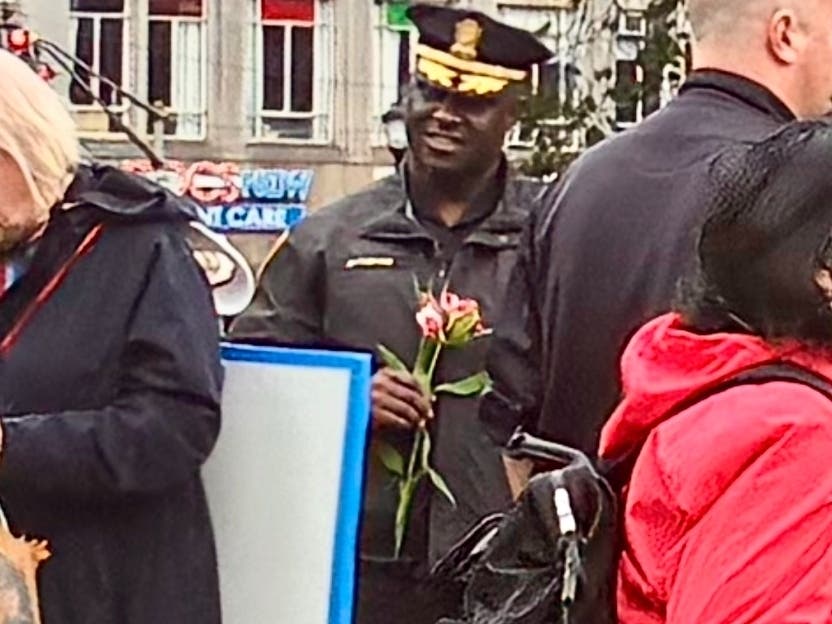 New Haven Police Department Assistant Chief Bertram Ettienne speaks with residents who attended a No Kings rally in June 2025.