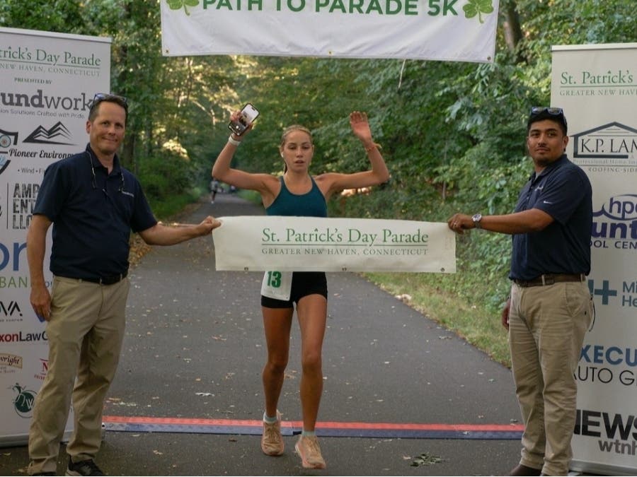 Women’s division winner Madison Zaneski, 16, of Madison, CT crosses the finish line at the August 2026 Path to the Parade. She led the women’s division completing the course in 21:39. This is Zaneski’s second year leading the women’s division.