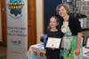 Marlaina Gilliam, a third grader from Chardon is presented a blue ribbon by Ohio Connections Academy teacher Jessica Hus