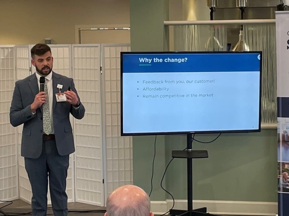 Sales Director Brian Cassidy gives a presentation on Lantern Hill's new financial structure at an event on campus.