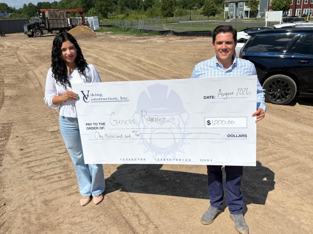 Anthony Gaglio, Jr., of Viking Construction presents Genesis Rameriz with the 2026 Viking Construction Scholarship Award during a site visit to Phase IV of the Willow Creek project in Hartford.