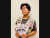 Lia Flores holds the multilingual brochures she created to build awareness of flood preparedness