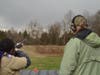 Scout Amy Nova Alarcon breaks a clay under the watchful eye of Bob Fix, President of the Upper Perkiomen Valley Sportsmen's Association