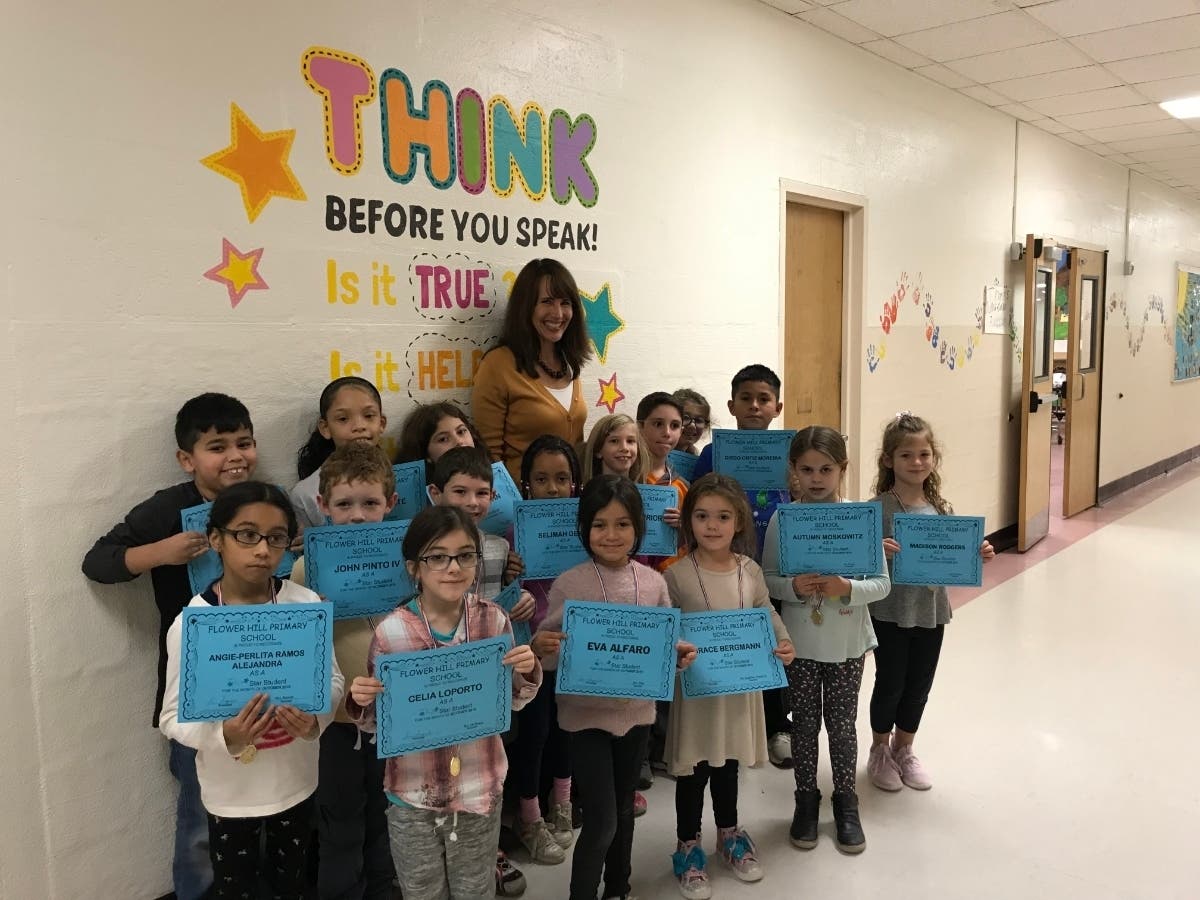 Principal Lucia Laguarda with Flower Hill School's Star Student Award recipients.