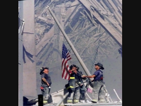 Firefighters raise an American Flag.