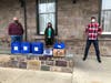 Dave Hansel and Kay McBride of the New Hope-Solebury Community Association pick up dinner from Tyler Strauss, manager of Lambertville Station Restaurant and Inn