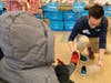 A&T Subaru representative helps a child find the right fit for their new shoes.