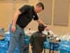 A&T Subaru representative helps child select new shoes.