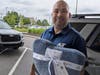 A&T Subaru General Manager Phil LaFiura poses with donation blanket.