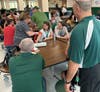 Frank Naccarato observes as teachers practice stop the bleed techniques during hands on training. 