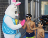 Participants greet the Easter Bunny with high-fives after finishing their swim session.