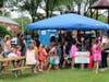 Families line up to participate in children's activities at MainStreet Libertyville's Lunch in the Park in downtown Libertyville. 