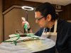 Artist Anthony Cuozzo of Ossining at work on his guitar-as-art piece for October 4th silent auction