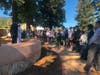 Captain Doug Beck addresses students as Major General Kent Hillhouse waits in the wings to share the story behind The Flame of Liberty Memorial