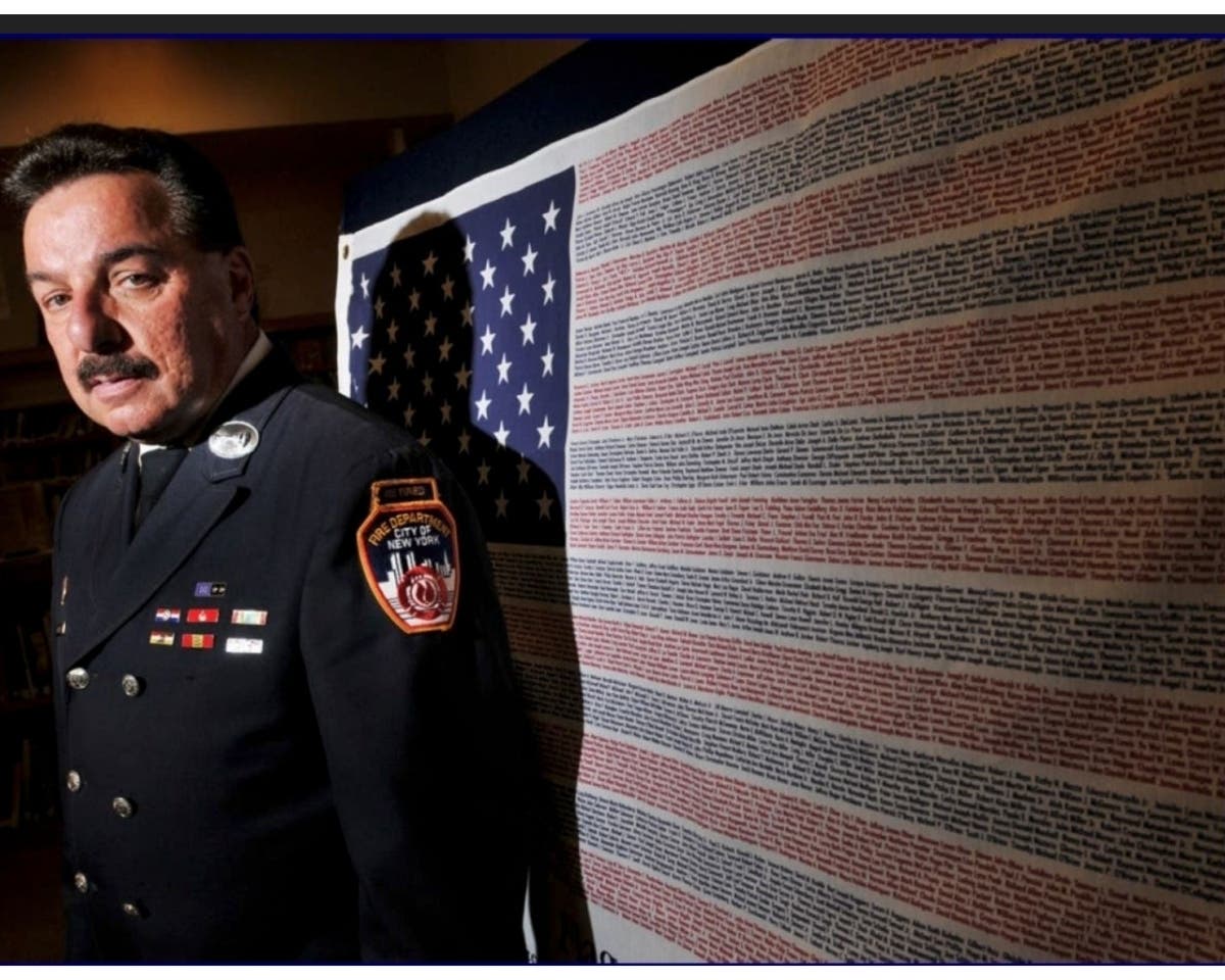 FDNY Lieutenant Joe Torrillo (Ret.) stands in honor of the firefighters, emergency service personnel, and civilians who lost lives due to the tragedy of September 11.