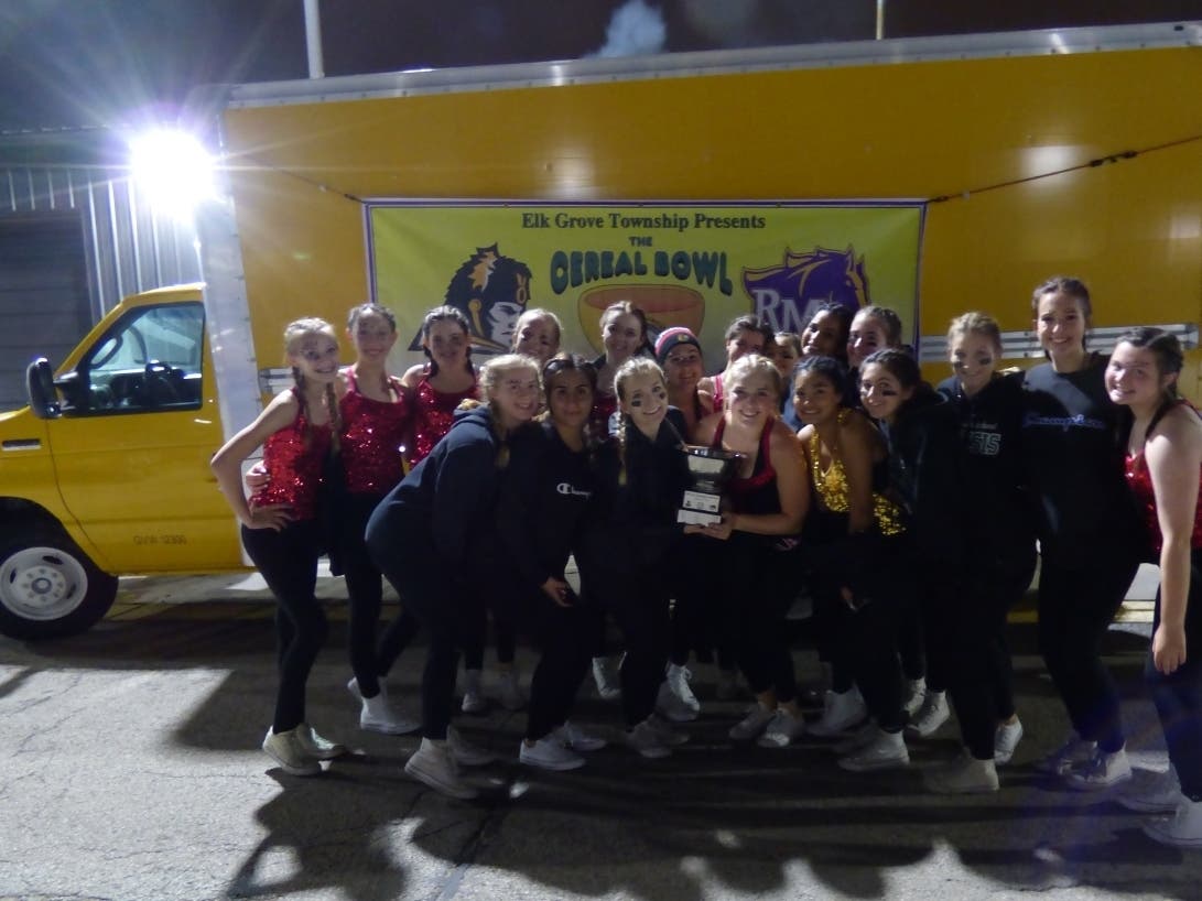 Local high school students who attended the game are pictured with the coveted Cereal Bowl trophy.