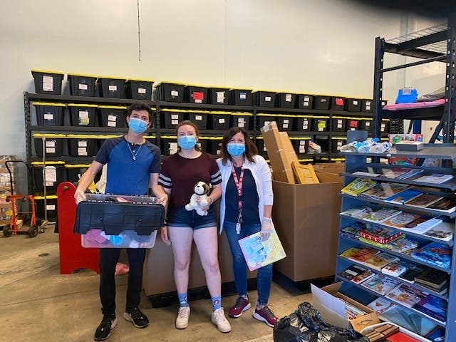 Left to right: GiveNKind volunteers Filippo, Martina and Lavinia LoBue are pictured as they unpacked donations at the organization’s Buffalo Grove warehouse in early June.