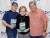 Annell and Jim Gerson, co-owners of Bookmiser, with author William Kent Krueger in October 2025. (Ken Ortloff)
