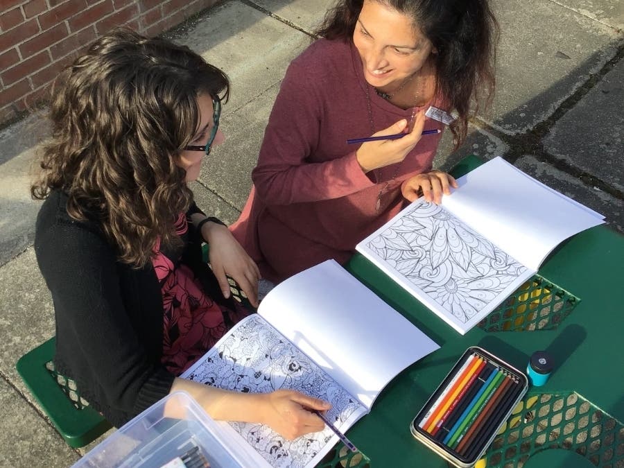 Librarians, Jessica and Gina, enjoy a coloring kit.