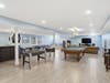 Finished lower level with custom bar, beverage refrigerator, dishwasher, ice maker, and flexible entertaining space.