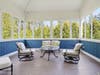 Four-season porch with interchangeable glass and screen panels for year-round enjoyment.