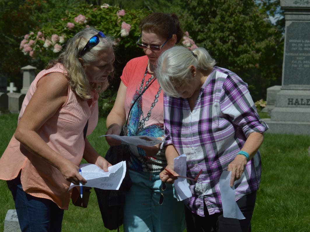 Mystery Scavenger Hunt participants deciphering a clue. 