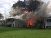 A Richlee Road home in Norwalk engulfed in flames on Monday. 