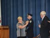 Police Chief Anderson receives his new badge from his wife, Virginia Anderson.