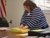 Maria L. Signore, moderator of the central absentee ballot recanvass, prepares the ballots for the recount. 