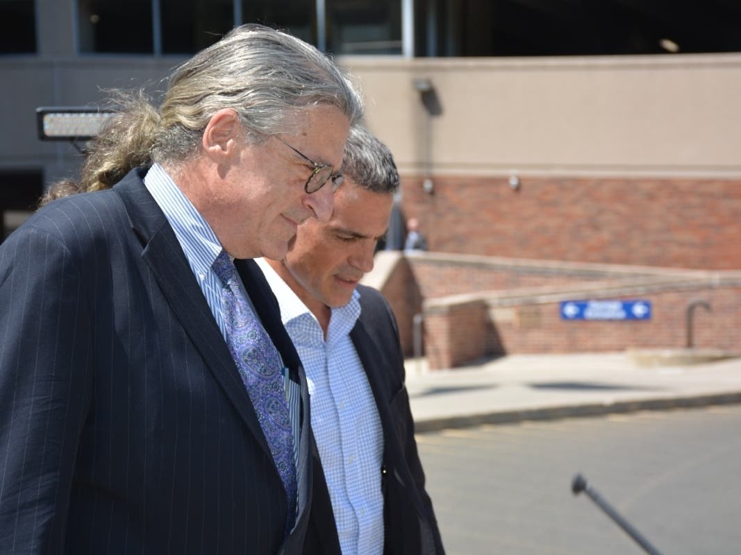 Attorney Norm Pattis, foreground, and the late Fotis Dulos leaving a court hearing in Stamford last summer.
