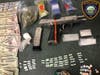 The handgun, drugs and cash seized by police on Monday after a traffic stop in Darien.