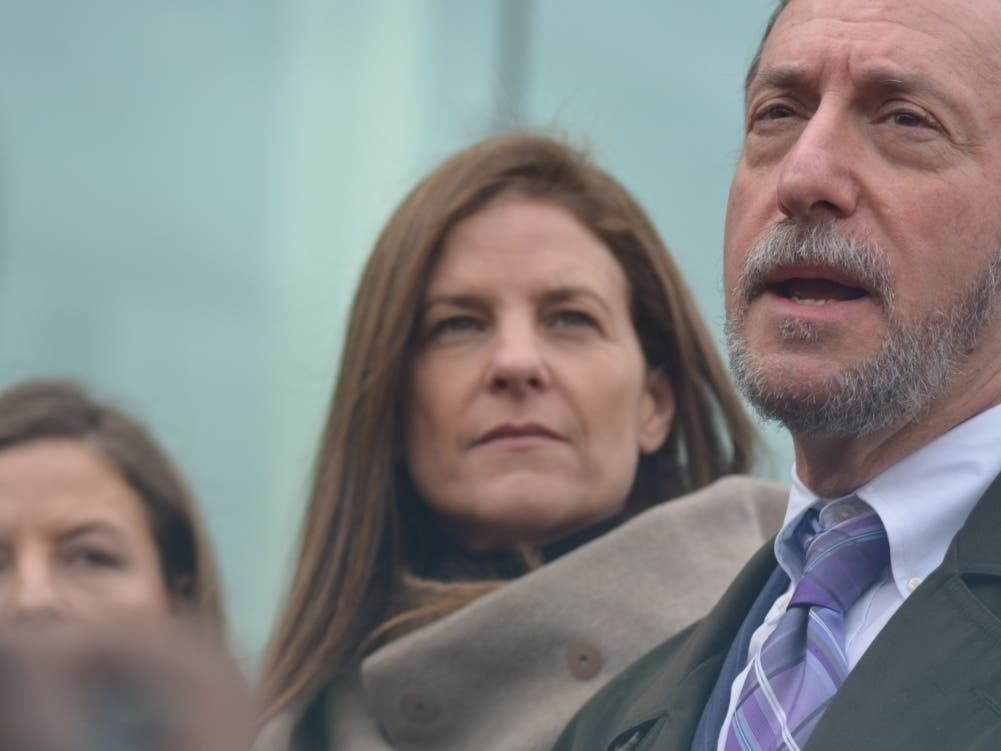 Michelle Troconis, left, looks on as her attorney, Jon Schoenhorn, speaks to the media following a recent court hearing in Stamford.