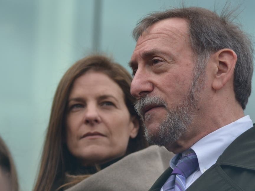 Michelle Troconis, left, looks on as her attorney, Jon Schoenhorn, speaks to the media following a recent court hearing in Stamford.