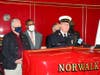 Norwalk Fire Chief Gino Gatto speaks at the launch event for a new recruitment drive to attract firefighter candidates. Mayor Harry Rilling (left, blue mask) looks on.
