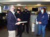 Norwalk Mayor Harry Rilling (left) presents a proclamation at the city's combined emergency dispatch center to supervisor Stacey Lariccia, Police Chief Thomas Kulhawik and supervisor Deborah Cirarletta.