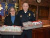 Fairfield resident Georgiana Stavrolakes, left, and Fairfield Police Lt. Michael Paris this week as Stavrolakes delivers her handmade dessert treats to the department.