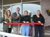 The ribbon-cutting at Here For You Clothing in the Brick Walk Promenade in Fairfield. From left, Mary Alice Limperopulos and Mark Barnhart from the town's economic development office, and store owner Ellie Haney and managing partner Emma Kilbride. 