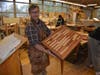Luke Allen, the Fairfield Warde High School teacher who runs the school's Woodshop, holds a table made by one of his Woodshop students.