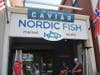 The exterior of Nordic Fish in downtown Fairfield, as two musicians play during the business' seventh anniversary.