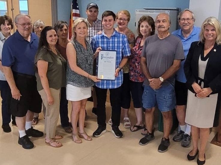 Pictured: Suffolk County Legislator Sarah Anker joins the Middle Island Civic Association 
and Assmeblywoman Jodi Giglio at a recent Civic Associaiton meeting to present Tyler Massian with a proclamation.