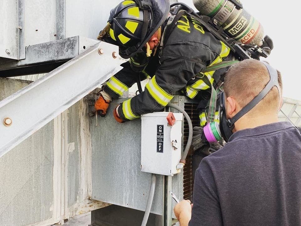 An Alameda County firefighter wearing breathing apparatus, trained to work with hazardous materials, stops an ammonia leak in Newark, Calif.