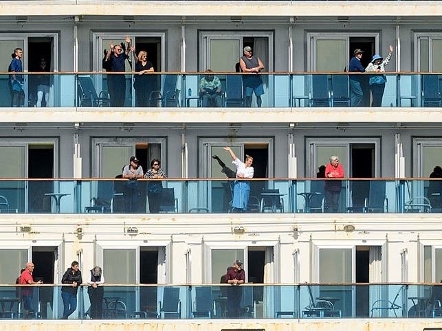  Passengers aboard the Grand Princess celebrate as they arrive in Oakland, Calif., on Monday, March 9, 2020. 