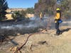 Firefighters spray hot spots.