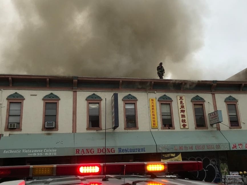The 2 story building has businesses on the ground floor and residences upstairs.