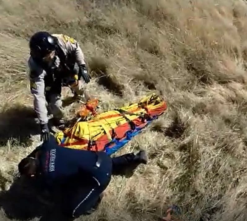 An injured glider pilot is airlifted to safety.