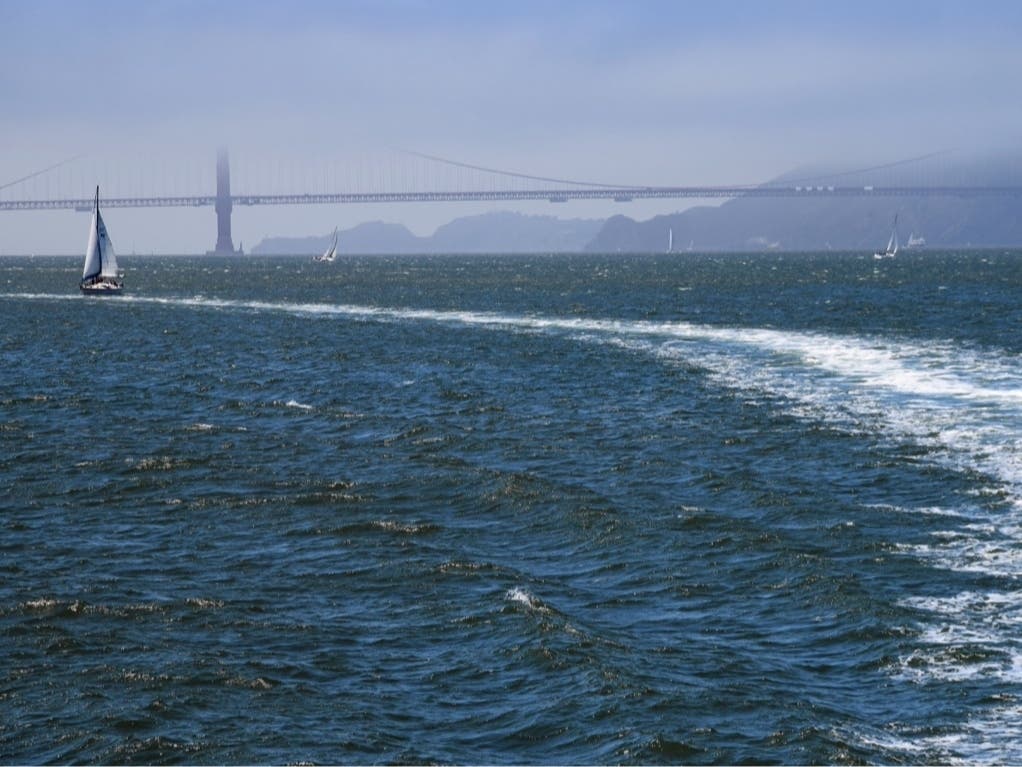 The Golden Gate Bridge partially obscured by clouds.