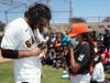 Giants shortstop Brandon Crawford signs an autograph at Gilman Playground Baseball Field dedication ceremony. 