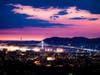 Oakland in the foreground, with San Francisco Bay and bridges in the background.