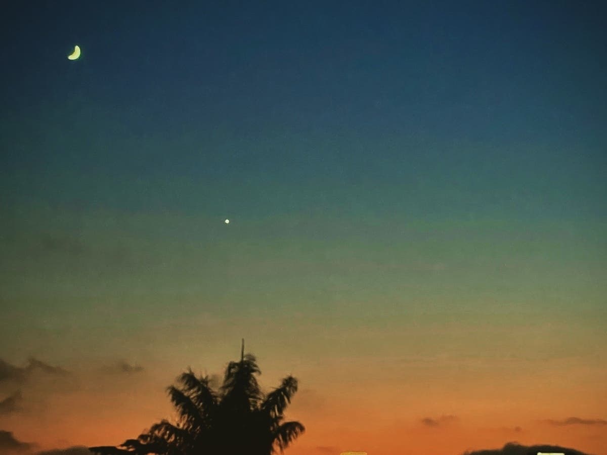 A crescent moon and the plant Venus, as seen from Cleveland Heights in Oakland, Calif.